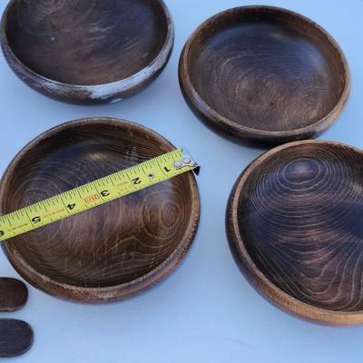 Wooden bowl with 4 salad bowls and fork and spoon