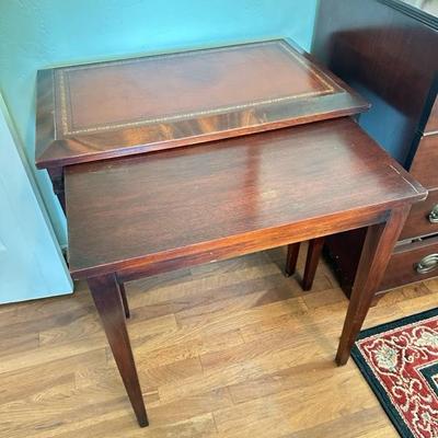 Sale Photo Thumbnail #111: Leather top nesting table set of two larger table 26” x 16” larger table has leather top smaller table has wood top
