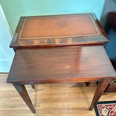 Sale Photo Thumbnail #119: Leather top nesting table set of two larger table 26” x 16” larger table has leather top smaller table has wood top