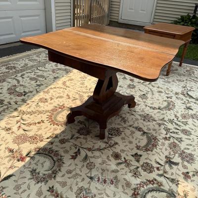 Folding table with music scroll motif base
