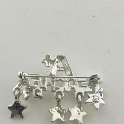 AAJ marked a plus teacher pin
