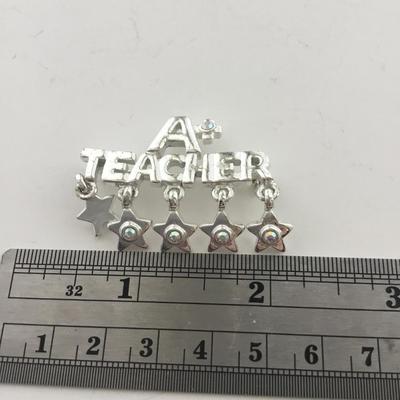AAJ marked a plus teacher pin