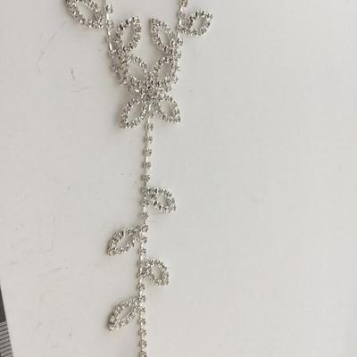 Silver tone bracelet with attached ring adjustable