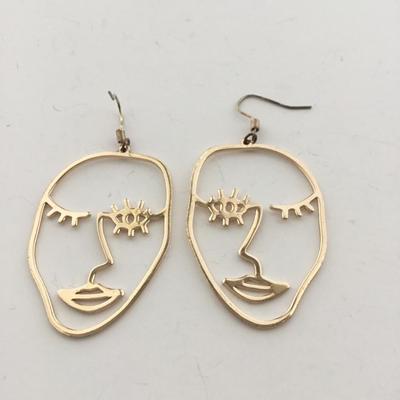 Gold tone face earrings