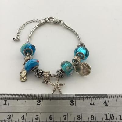 Unmarked beautiful blue beaded charm bracelet