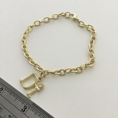 Gold tone DI charm bracelet