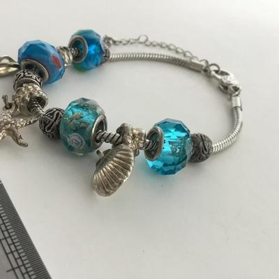 Unmarked beautiful blue beaded charm bracelet