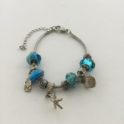 Unmarked beautiful blue beaded charm bracelet