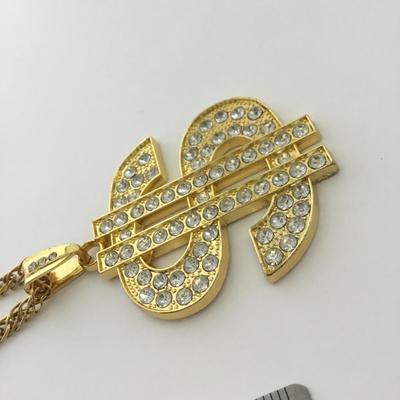 Gold tone money sign statement necklace