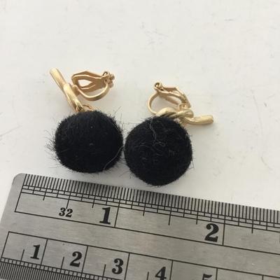 Gold tone black fuzzy clip on earrings