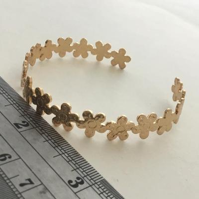 Gold tone flower cuff bracelet