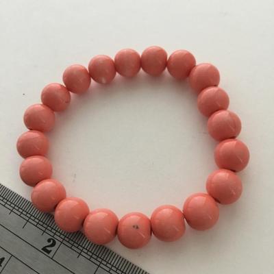 Coral colored beaded stretchy fashion bracelet