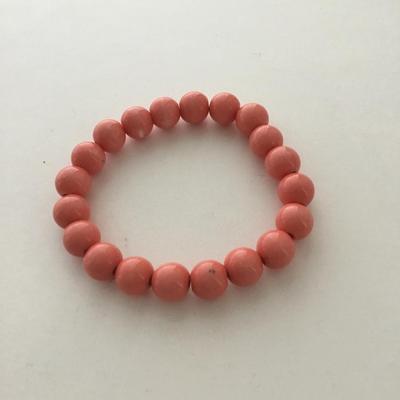 Coral colored beaded stretchy fashion bracelet