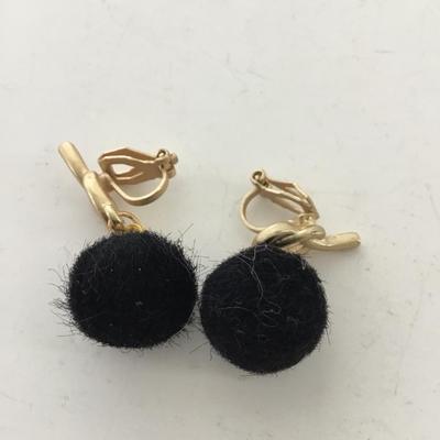 Gold tone black fuzzy clip on earrings