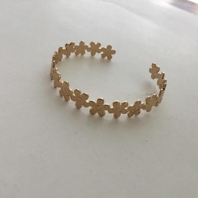 Gold tone flower cuff bracelet