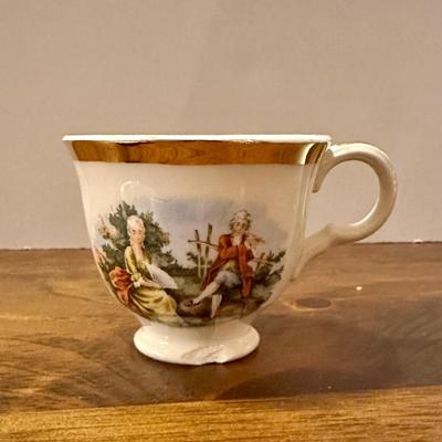 Miniature 2 Saucers and Teacup (with chip)