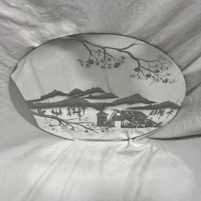 Sandblasted art onto mirror of Cabin In mountains