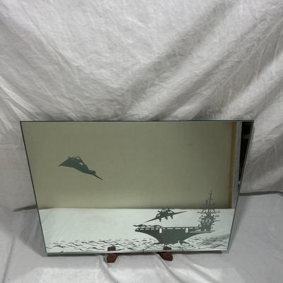 Sandblasted art onto mirror of aircraft carriers with bombers taking off