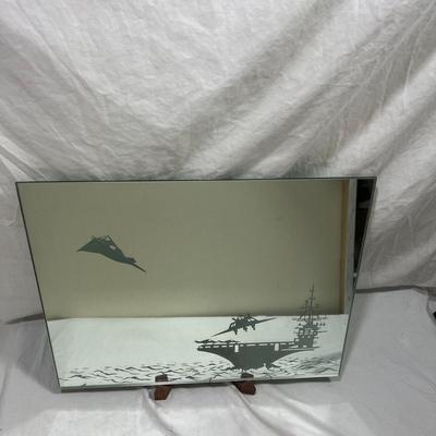 Sandblasted art onto mirror of aircraft carriers with bombers taking off