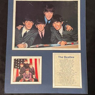 Framed Beatles memorabilia mat featuring promotional photos and an album chronology discography list.