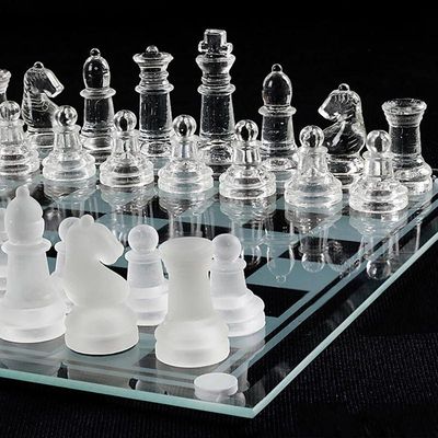 Modern glass chess set featuring clear and frosted pieces on a matching glass board.