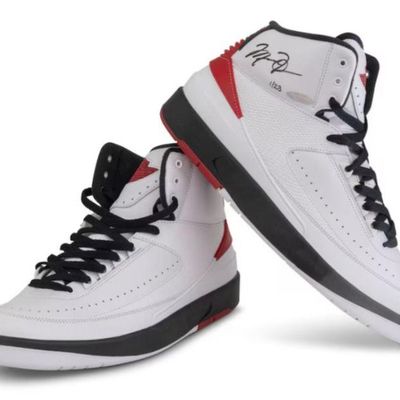 Pair of autographed Air Jordan 2 Retro high-top sneakers in white, black, and red colorway, featuring a Michael Jordan signature and...