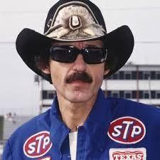 Sale Photo Thumbnail #31: Richard Petty racing memorabilia, featuring a black felt cowboy hat with feather detail and dark sunglasses.