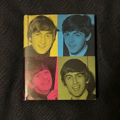 Vintage 1960s The Beatles hardcover book or album featuring a four-quadrant pop art style cover with portraits of John, Paul, Ringo, and...