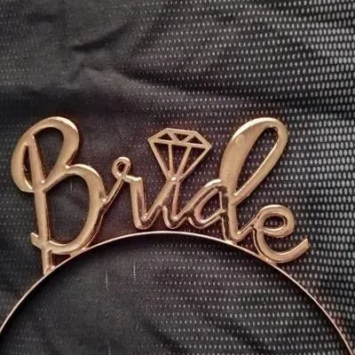 Rose gold-tone metal "Bride" headband featuring a diamond icon, suitable for bridal showers or bachelorette parties.