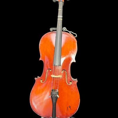 Sale Photo Thumbnail #2: This piece is a high quality student cello. There are areas of scuffs, missing veneer, and minimal wood loss ath the base and around the edges. There is Sharpie writing on the reverse. Measurement: 38” x 12”. Pre-auction estimate: $750-$1000. [MI]