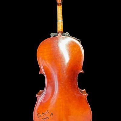 Sale Photo Thumbnail #5: This piece is a high quality student cello. There are areas of scuffs, missing veneer, and minimal wood loss ath the base and around the edges. There is Sharpie writing on the reverse. Measurement: 38” x 12”. Pre-auction estimate: $750-$1000. [MI]