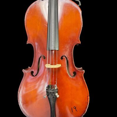 Sale Photo Thumbnail #3: This piece is a high quality student cello. There are areas of scuffs, missing veneer, and minimal wood loss ath the base and around the edges. There is Sharpie writing on the reverse. Measurement: 38” x 12”. Pre-auction estimate: $750-$1000. [MI]