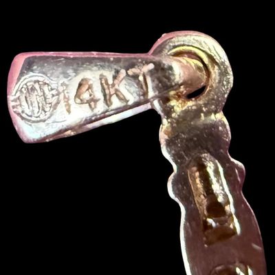 Sale Photo Thumbnail #7: This 14K yellow gold cross pendant features channel set diamonds. It measures approximately 1” long. The weight is 1.84 grams. [AG]
