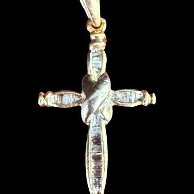 Sale Photo Thumbnail #6: This 14K yellow gold cross pendant features channel set diamonds. It measures approximately 1” long. The weight is 1.84 grams. [AG]