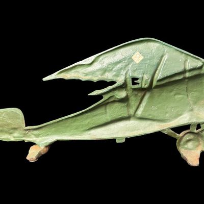 Sale Photo Thumbnail #17: This piece is constructed of cast iron, and was made in Taiwan. The original sticker is on the reverse. This was typically used as a door stop or wall hanging. It is modeled after a WW1 bi-plane. There is age related wear, including minor surface rust. Me