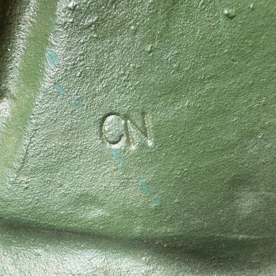 Sale Photo Thumbnail #19: This piece is constructed of cast iron, and was made in Taiwan. The original sticker is on the reverse. This was typically used as a door stop or wall hanging. It is modeled after a WW1 bi-plane. There is age related wear, including minor surface rust. Me
