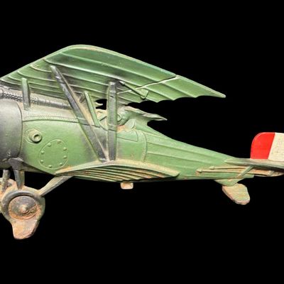 Sale Photo Thumbnail #16: This piece is constructed of cast iron, and was made in Taiwan. The original sticker is on the reverse. This was typically used as a door stop or wall hanging. It is modeled after a WW1 bi-plane. There is age related wear, including minor surface rust. Me