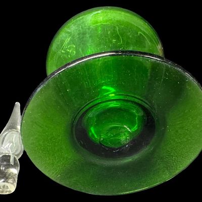Sale Photo Thumbnail #26: This mid-century hand-blown art glass decanter is believed to be made by the Bischoff Glass Company in the 1950s or 1960s. The color is vibrant emerald green. There is a rough pontil mark on the base, a clear applied handle, and a clear flame-shaped stopp