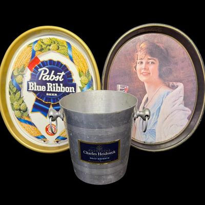 Sale Photo Thumbnail #35: This assortment includes a Coca-Cola tray, a Pabst Blue Ribbon tray, and a Bud Light bucket. Total of three pieces. Measurement of trays: 15” x 12.5”. [MI]