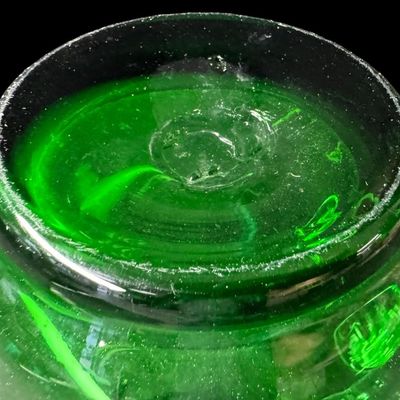 Sale Photo Thumbnail #54: This mid-century hand-blown art glass pitcher is believed to be made by Blenko, or another art glass company of the era. It is emerald green in color, with a clear glass applied handle. There is a rough pontil on the base. There is minor age related wear,