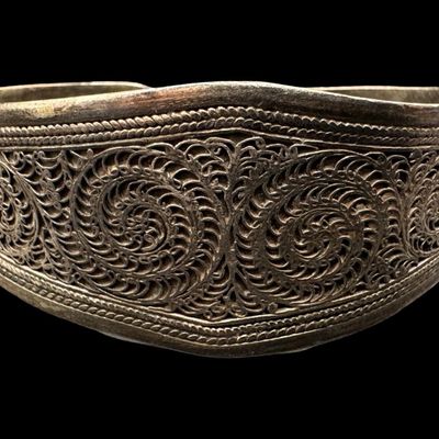Sale Photo Thumbnail #65: These bracelets have applied filigree, with intricate scrolling. Both pieces are marked “925.” The largest cuff measures 3” wide by 1.25” high. Both cuffs are bent somewhat. The total weight is 76.15 grams. [AG]