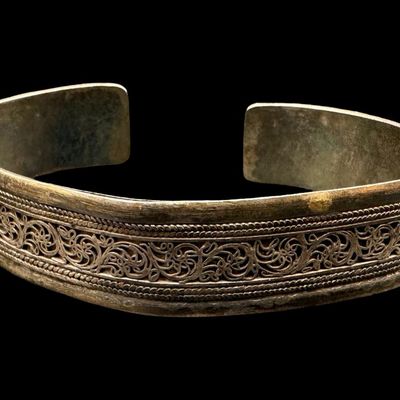 Sale Photo Thumbnail #67: These bracelets have applied filigree, with intricate scrolling. Both pieces are marked “925.” The largest cuff measures 3” wide by 1.25” high. Both cuffs are bent somewhat. The total weight is 76.15 grams. [AG]