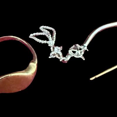 Sale Photo Thumbnail #69: This 10K gold assortment includes a vintage signet ring that is missing a stone and appears to have a worn down monogram; a single pearl stud earring; and a belly button ring that is missing the top ball. The ring size is 4.25. The total weight is 2.32 gr