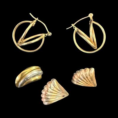 Sale Photo Thumbnail #71: This 14K gold earrings assortment includes a pair of yellow gold twist hoop earrings, a pair of tri-color shell earrings (one has damage), and a single yellow and white gold earring. The total weight is 2.33 grams. The gold content of some items was confi