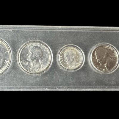Sale Photo Thumbnail #84: This 1964 mint set includes a Kennedy half, a Washington quarter, and a Roosevelt dime, which all have a silver content of 90%. Also included are a nickel and a penny. [PM]