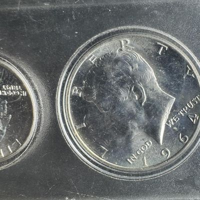 Sale Photo Thumbnail #85: This 1964 mint set includes a Kennedy half, a Washington quarter, and a Roosevelt dime, which all have a silver content of 90%. Also included are a nickel and a penny. [PM]