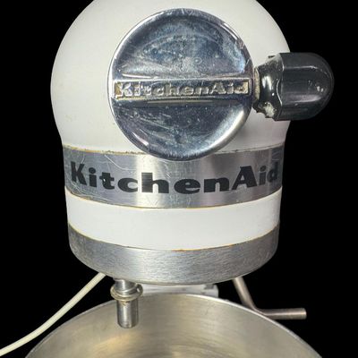 Sale Photo Thumbnail #102: This features all-metal internal gears, and was built during a period when Hobart manufactured KitchenAid appliances. It is complete with a whisk and dough hook. Working at the time of catalog. Measurement: 17” x 13” x 9”. [LG]