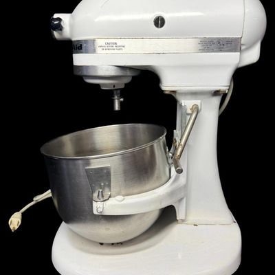 Sale Photo Thumbnail #103: This features all-metal internal gears, and was built during a period when Hobart manufactured KitchenAid appliances. It is complete with a whisk and dough hook. Working at the time of catalog. Measurement: 17” x 13” x 9”. [LG]