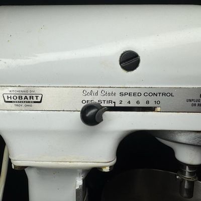 Sale Photo Thumbnail #105: This features all-metal internal gears, and was built during a period when Hobart manufactured KitchenAid appliances. It is complete with a whisk and dough hook. Working at the time of catalog. Measurement: 17” x 13” x 9”. [LG]