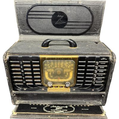 Sale Photo Thumbnail #110: This is a Zenith Model 8G005-YTZ1 portable tube radio. It was manufactured in 1948, and features six bands for AM and shortwave listening. It is built into a portable “suitcase” style cabinet covered in black leatherette, with a front drop-down “chi